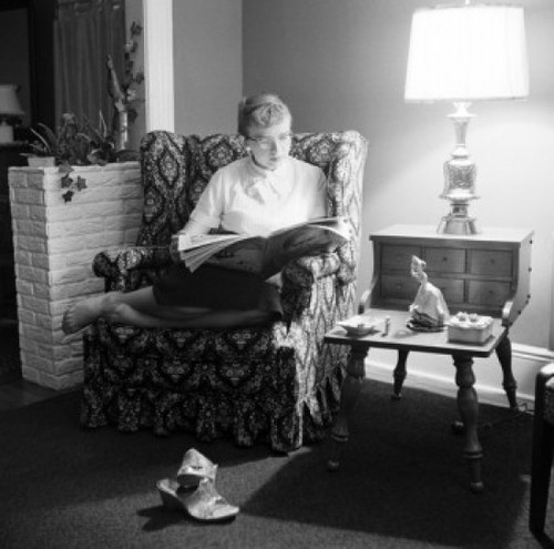 Young woman reading magazine in living room Poster Print - Item # VARSAL2552184