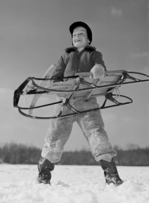 Boy holding sled Poster Print