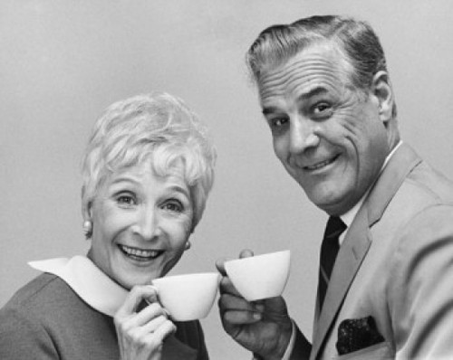 Portrait of a senior couple holding tea cups and smiling Poster Print - Item # VARSAL25527404B