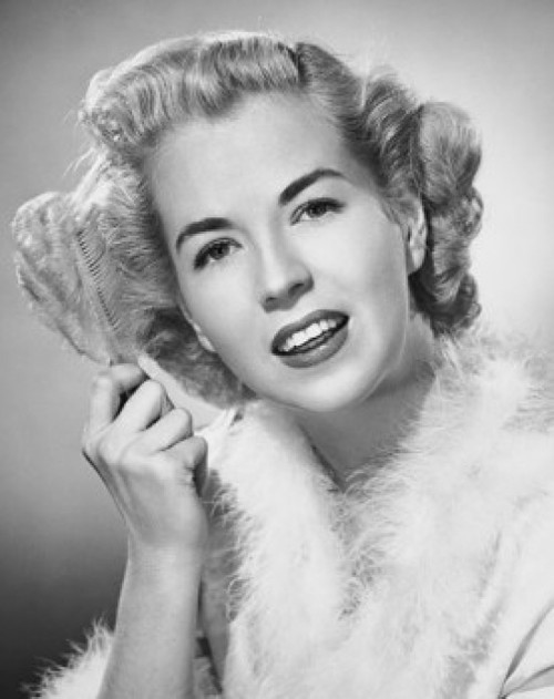 Portrait of a young woman combing her hair Poster Print - Item # VARSAL25542556
