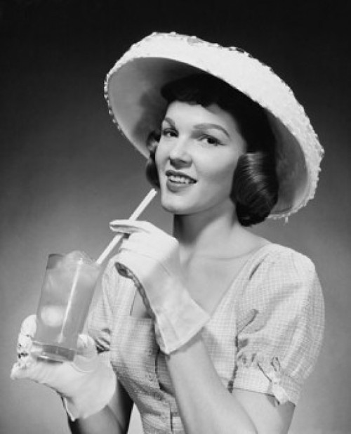 Portrait of a young woman drinking lemonade Poster Print