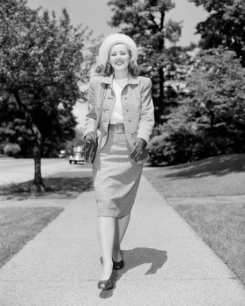 Young elegant woman walking down street Poster Print - Item # VARSAL255422381