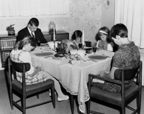Mature couple with their three children praying at a dining table on Thanksgiving Day Poster Print - Item # VARSAL2552302