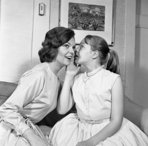 Girl hissing in young woman's ear Poster Print - Item # VARSAL255421099