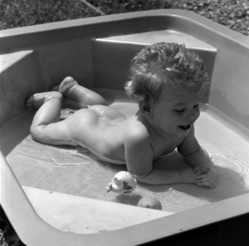Naked baby lying on front in wading pool Poster Print - Item # VARSAL2559101