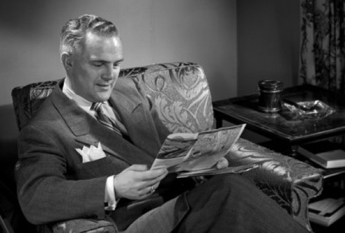 Man reading magazine in chair Poster Print - Item # VARSAL25528168