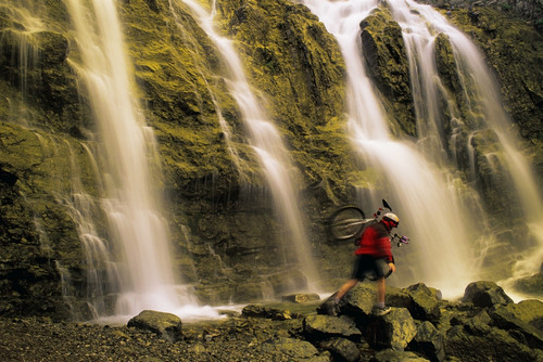 Time Delay Of Waterfall With Cyclist Carrying Bicycle PosterPrint - Item # VARDPI6138