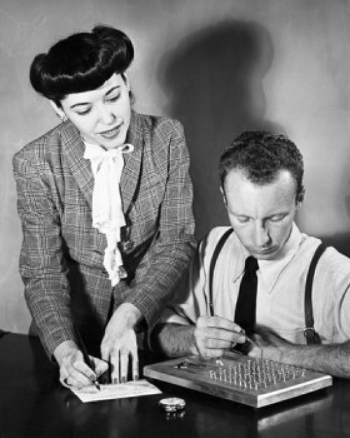 Businessman undergoing a manual dexterity test with a businesswoman standing beside him Poster Print - Item # VARSAL25526243