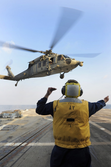 November 6, 2012 - Boatswain_?_s Mate directs an MH-60S Sea Hawk helicopter as it approaches the flight deck of guided-missile destroyer USS Farragut Poster Print - Item # VARPSTSTK106684M