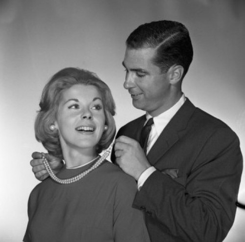 Man fastening to woman pearl necklace  studio shot Poster Print - Item # VARSAL255417383