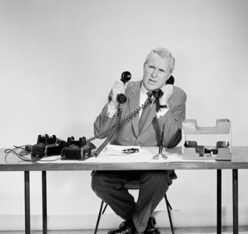 Businessman using two telephones Poster Print - Item # VARSAL2552192