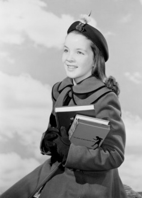 School girl holding books against cloudy sky Poster Print - Item # VARSAL255420209