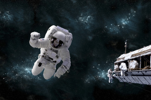 Artist's concept of astronaut floating in outer space while his fellow astronauts work on the space station. A galactic scene serves as background. Poster Print - Item # VARPSTMRC200110S
