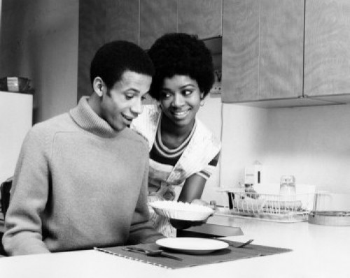 Young woman serving food to a young man Poster Print - Item # VARSAL25521675