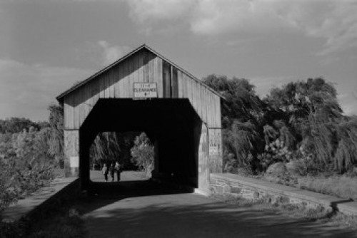 USA  Pennsylvania  People walking under covered bridge Poster Print - Item # VARSAL255423426