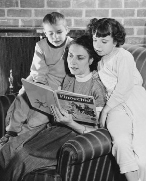 Mother and children reading a book Poster Print