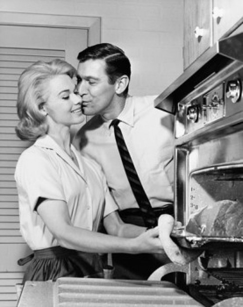 Mid adult man kissing a mid adult woman Poster Print - Item # VARSAL25535508