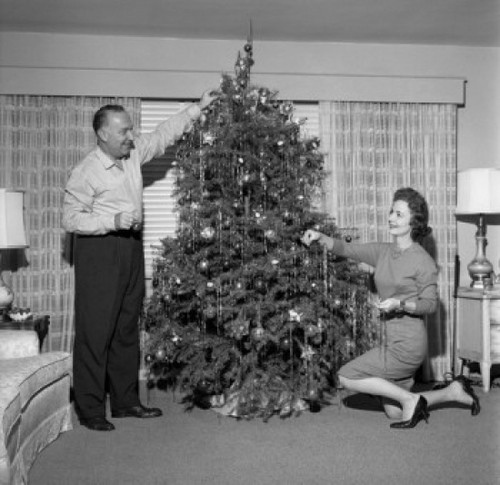 Mature couple decorating Christmas tree Poster Print - Item # VARSAL255417343