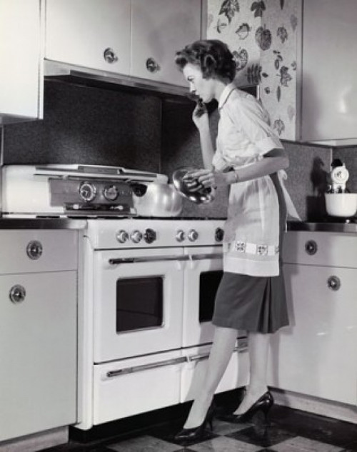 Mid adult woman cooking food in the kitchen Poster Print - Item # VARSAL25535455
