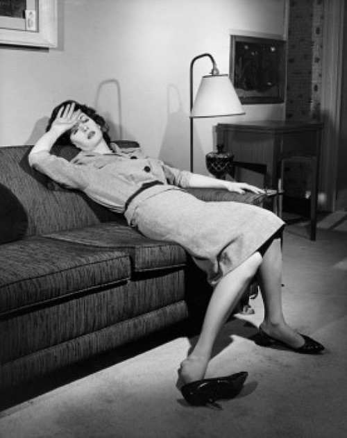 Young woman resting on a couch Poster Print - Item # VARSAL255955