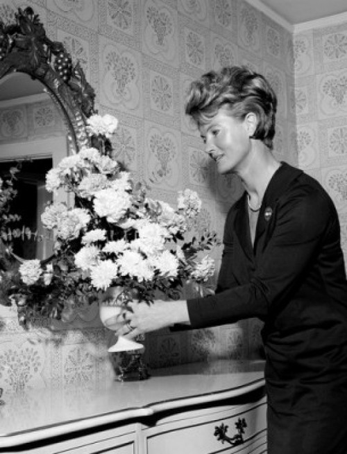 Woman arranging vase of cut flowers Poster Print - Item # VARSAL25549225