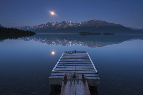 Boat dock with a full moon rising over the Chigmit Mountains at Lake Clark in Lake Clark National Park and Preserve, Alaska. PosterPrint - Item # VARDPI12290623