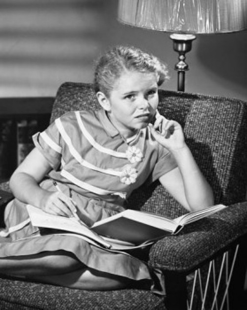 Girl sitting with a book in front of her Poster Print - Item # VARSAL25513870B