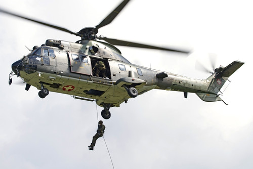 A Eurocopter AS332 Super Puma of the Swiss Air Force in flight over Locarno, Switzerland Poster Print - Item # VARPSTNCT100021M