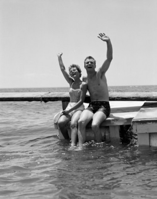 Young couple waving on pier at sea Poster Print - Item # VARSAL255416881B