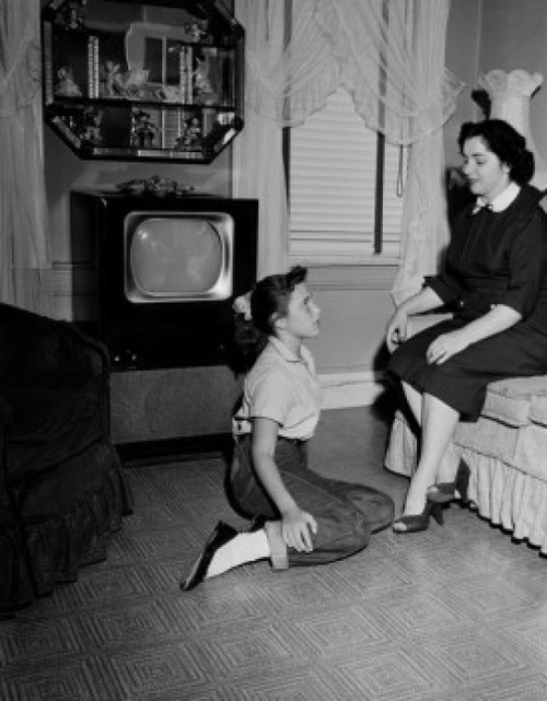 Girl talking with mother in living room Poster Print - Item # VARSAL255422197