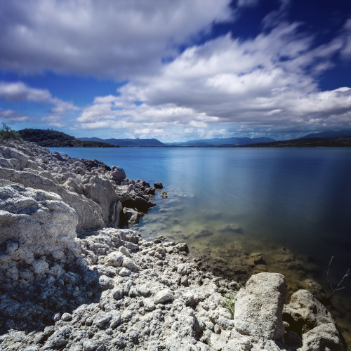 Tranquil lake and rocky shore against cloudy sky, Sardinia, Italy Poster Print - Item # VARPSTEVK200087S