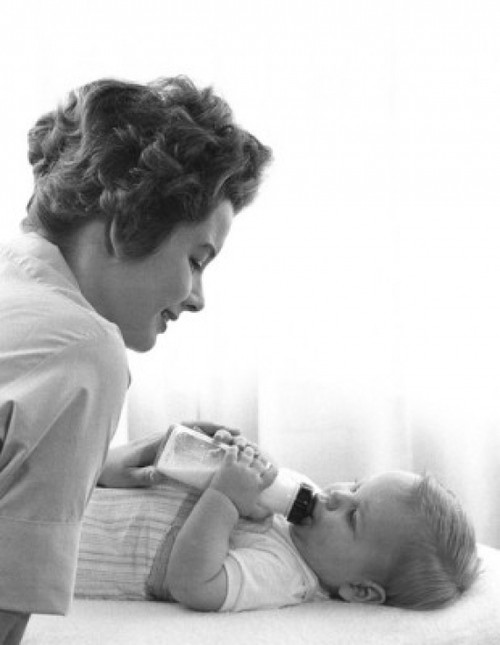 Mother feeding baby with baby bottle Poster Print - Item # VARSAL2559869