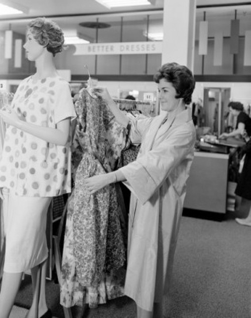 Woman holding dress in clothes shop Poster Print - Item # VARSAL255417874