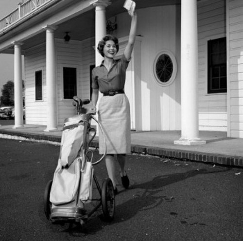 Woman with gold bag  waving outside golf country club Poster Print - Item # VARSAL255417153