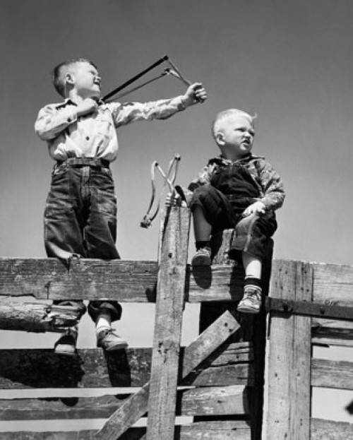 Low angle view of two boys holding slingshots Poster Print - Item # VARSAL25516273