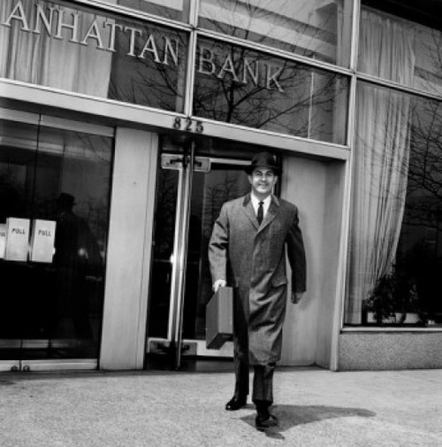 Businessman walking out of bank carrying briefcase Poster Print - Item # VARSAL25548545