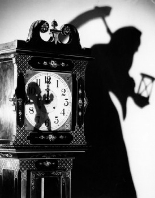 Close-up of a clock with the shadow of a person carrying a scythe Poster Print