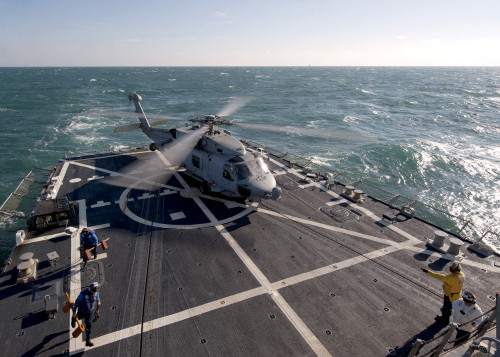 Atlantic Ocean, January 12, 2012 - Flight deck personnel remove chocks and chains from an SH-60B Sea Hawk helicopter before launch aboard the guided-missile destroyer USS James E. Williams Poster Print - Item # VARPSTSTK105249M