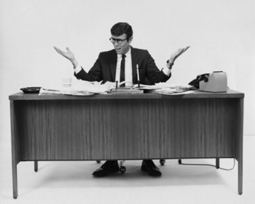 Businessman sitting at a desk in an office Poster Print - Item # VARSAL25548381A