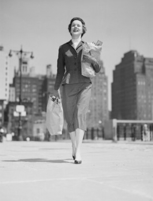 Cheerful businesswoman carrying shopping bags Poster Print - Item # VARSAL255422001