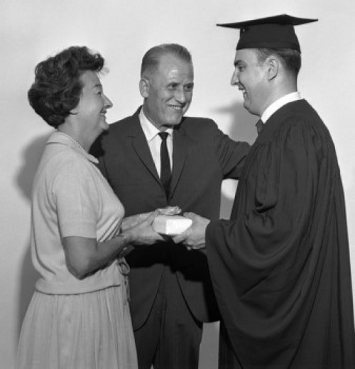 Parents giving gift to son at graduation Poster Print - Item # VARSAL255417907