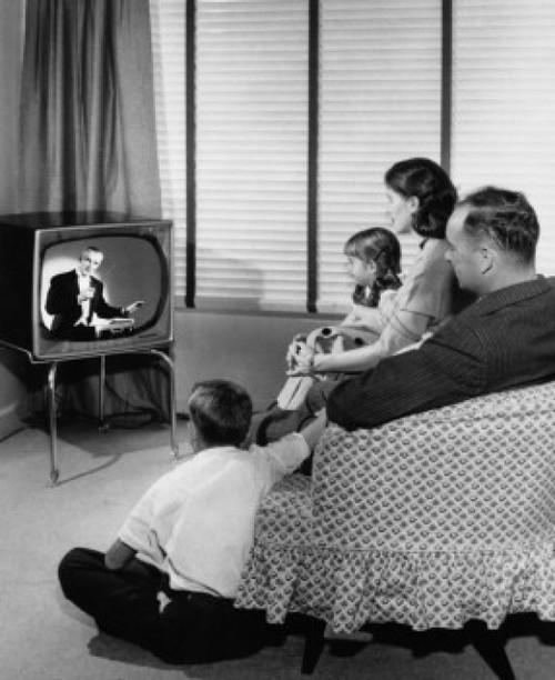 Parents with their two children watching television Poster Print - Item # VARSAL2551601