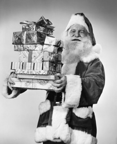 Portrait of Santa Claus carrying a stack of Christmas presents Poster Print - Item # VARSAL25529253
