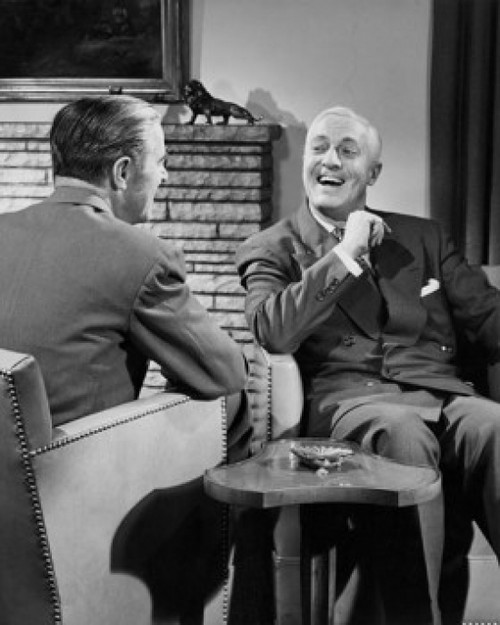 Two businessmen talking indoors Poster Print