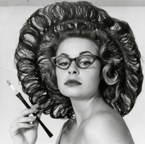 Close-up of a young woman holding a cigarette holder Poster Print - Item # VARSAL2551032A Close-up of a young woman holding a cigarette holder Poster Print - Item # VARSAL2551032A