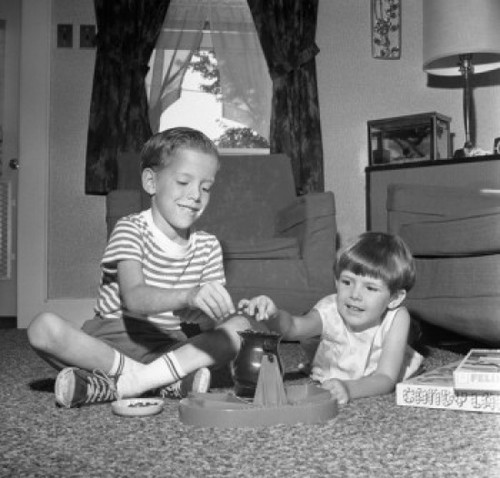 Two boys playing with toy game on living room floor Poster Print - Item # VARSAL255420921