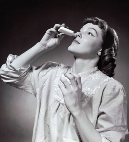 Young woman using nasal spray Poster Print - Item # VARSAL25534787