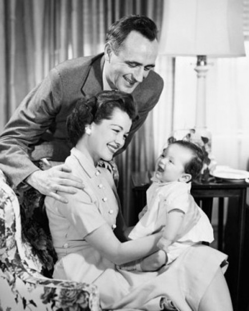 Mid adult couple looking at daughter and smiling Poster Print - Item # VARSAL25591488