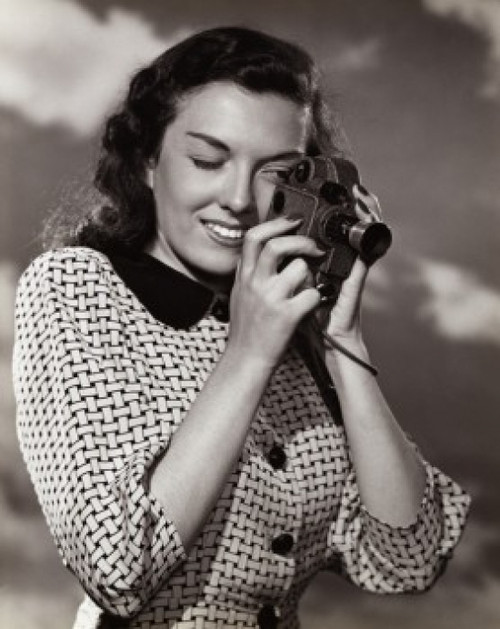 Young woman taking a photograph Poster Print