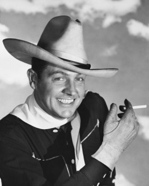 Portrait of a cowboy holding a cigarette  smiling Poster Print - Item # VARSAL25527784